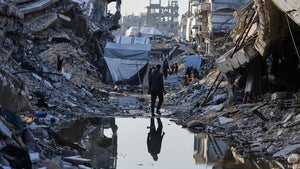 Palestinians walk amid the rubble of destroyed homes and buildings in Jabaliya, northern Gaza Strip