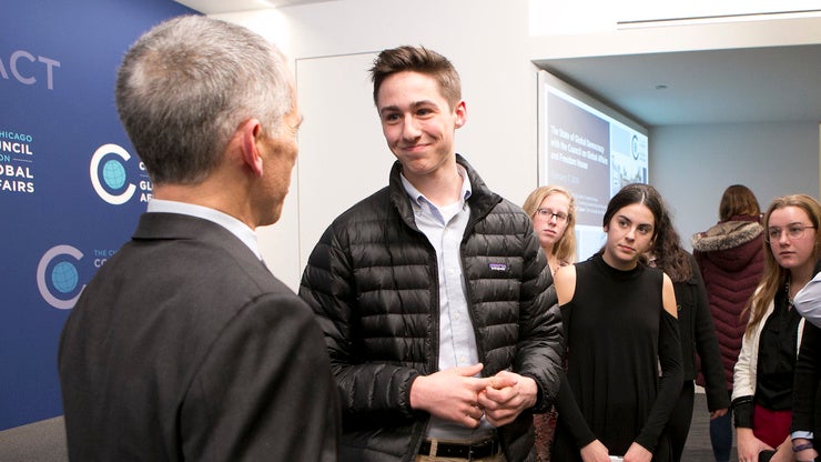 Interns meeting a speaker after a public program
