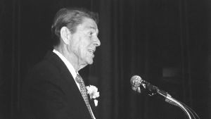 Black and white photo of Ronald Reagan at podium.