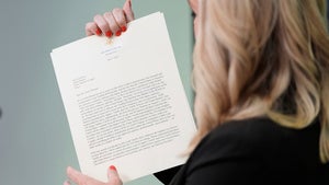 White House Press Secretary Karoline Leavitt holds a letter announcing tariffs